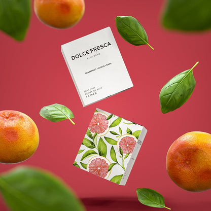 dolce fresca bath bomb by bare skin bar in grey box shown with grapefruit and basil leaf